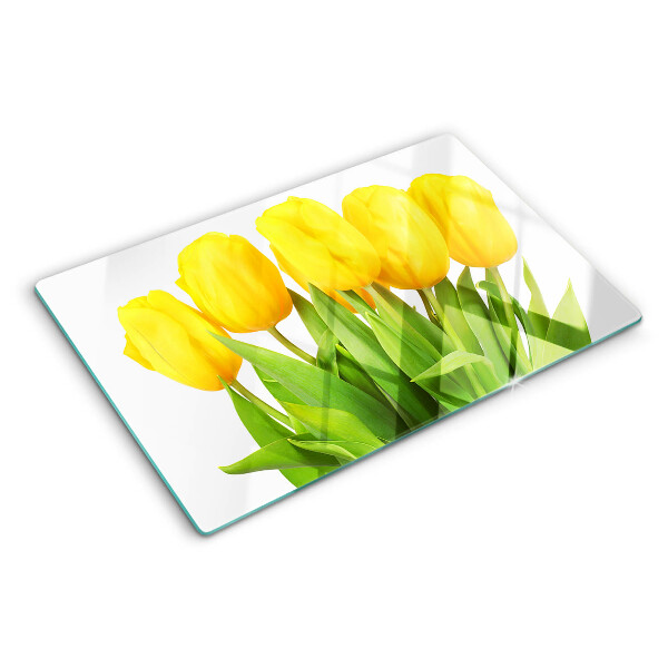 Üveg vágódeszka fényképpel Sárga tulipánok zöld háttér előtt