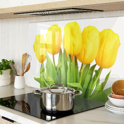 Üveg vágódeszka fényképpel Sárga tulipánok zöld háttér előtt
