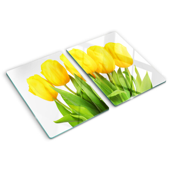 Üveg vágódeszka fényképpel Sárga tulipánok zöld háttér előtt