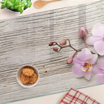 Üveg vágódeszka fényképpel Orchideák fa háttéren