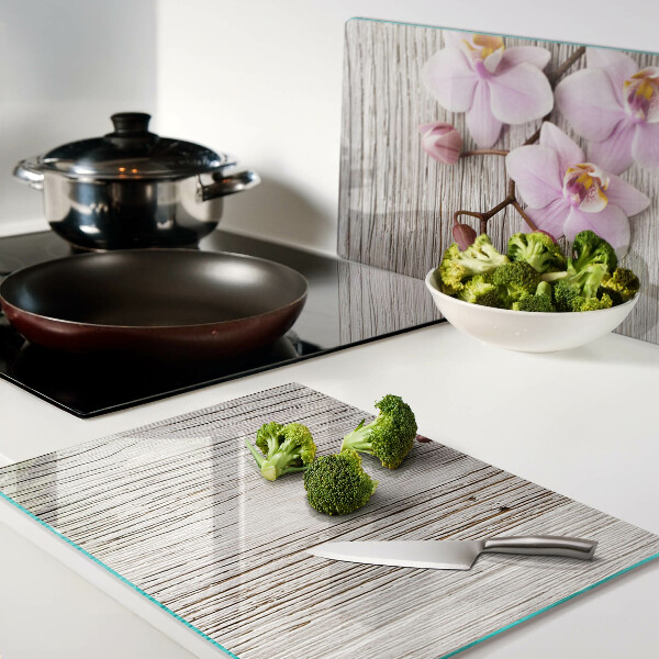 Üveg vágódeszka fényképpel Orchideák fa háttéren