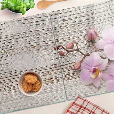 Üveg vágódeszka fényképpel Orchideák fa háttéren