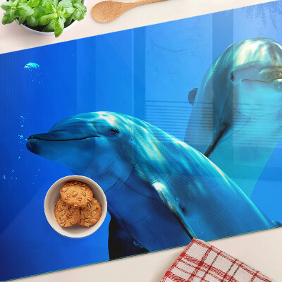 Üveg vágódeszka fényképpel Delfinek a vízben