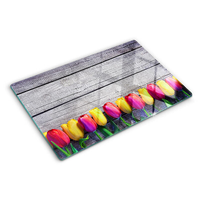 Üveg vágódeszka Tulipánok fa háttéren