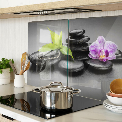 Üveg vágódeszka Kövek és orchidea a háttérben
