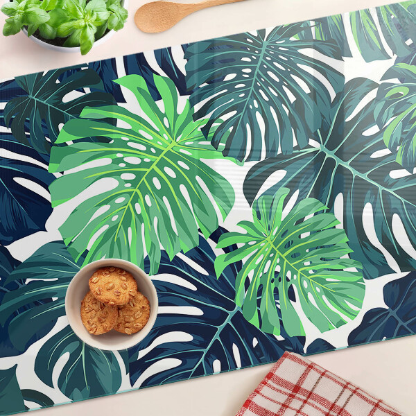 Üveg vágódeszka Monstera levelek trópusi háttéren