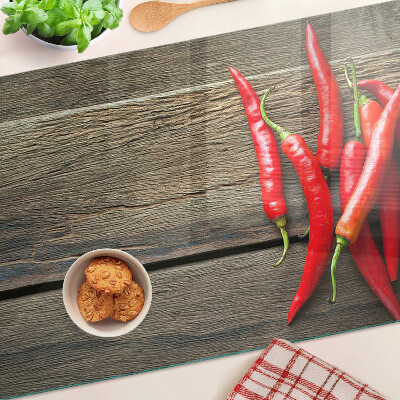 Üveg vágódeszka Chili paprika fa háttéren