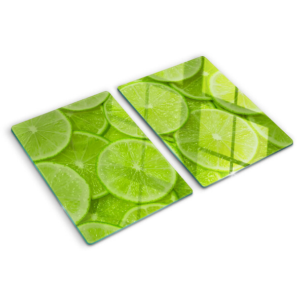 Üveg vágódeszka fényképpel Lime szeletek zöld háttéren