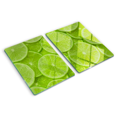 Üveg vágódeszka fényképpel Lime szeletek zöld háttéren