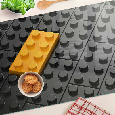 Edzett üveg vágódeszka LEGO kockák fekete háttéren