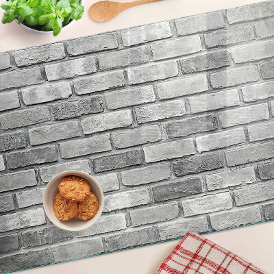 Üveg vágódeszka fényképpel Téglafal szürke árnyalatokban