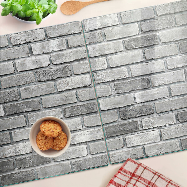 Üveg vágódeszka fényképpel Téglafal szürke árnyalatokban